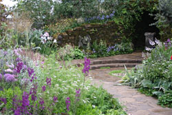 romantic garden with statue, trees, shrubs, pergola