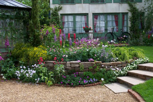 romantic garden with statue, trees, shrubs, pergola